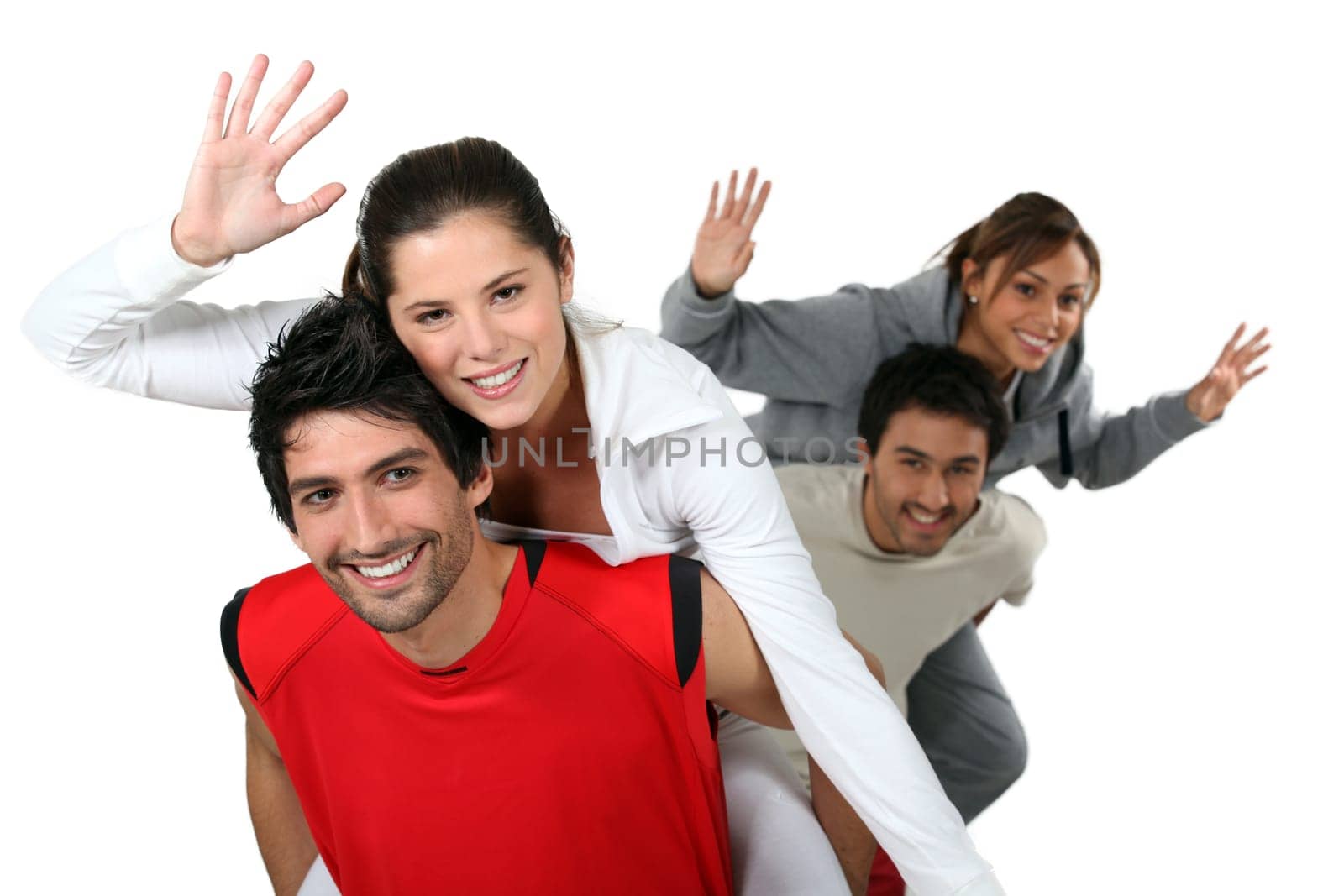 Two couple doing a piggy back ride race.