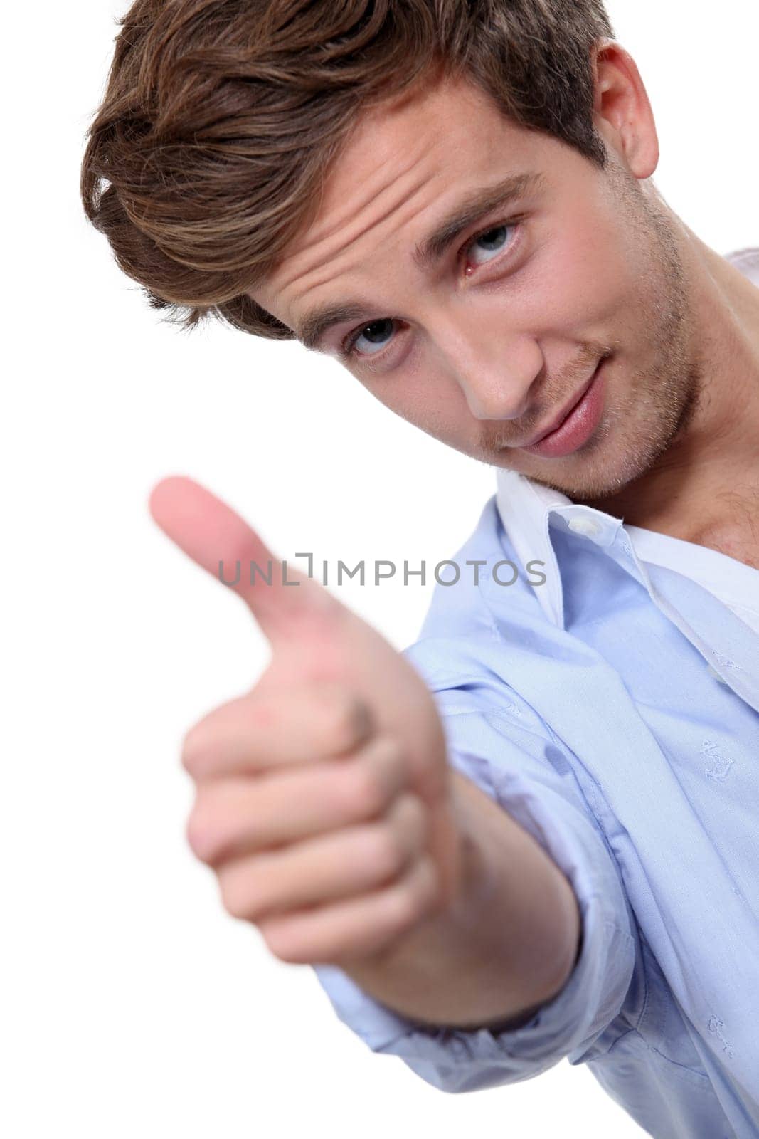 close-up portrait of young man thumb up frowning