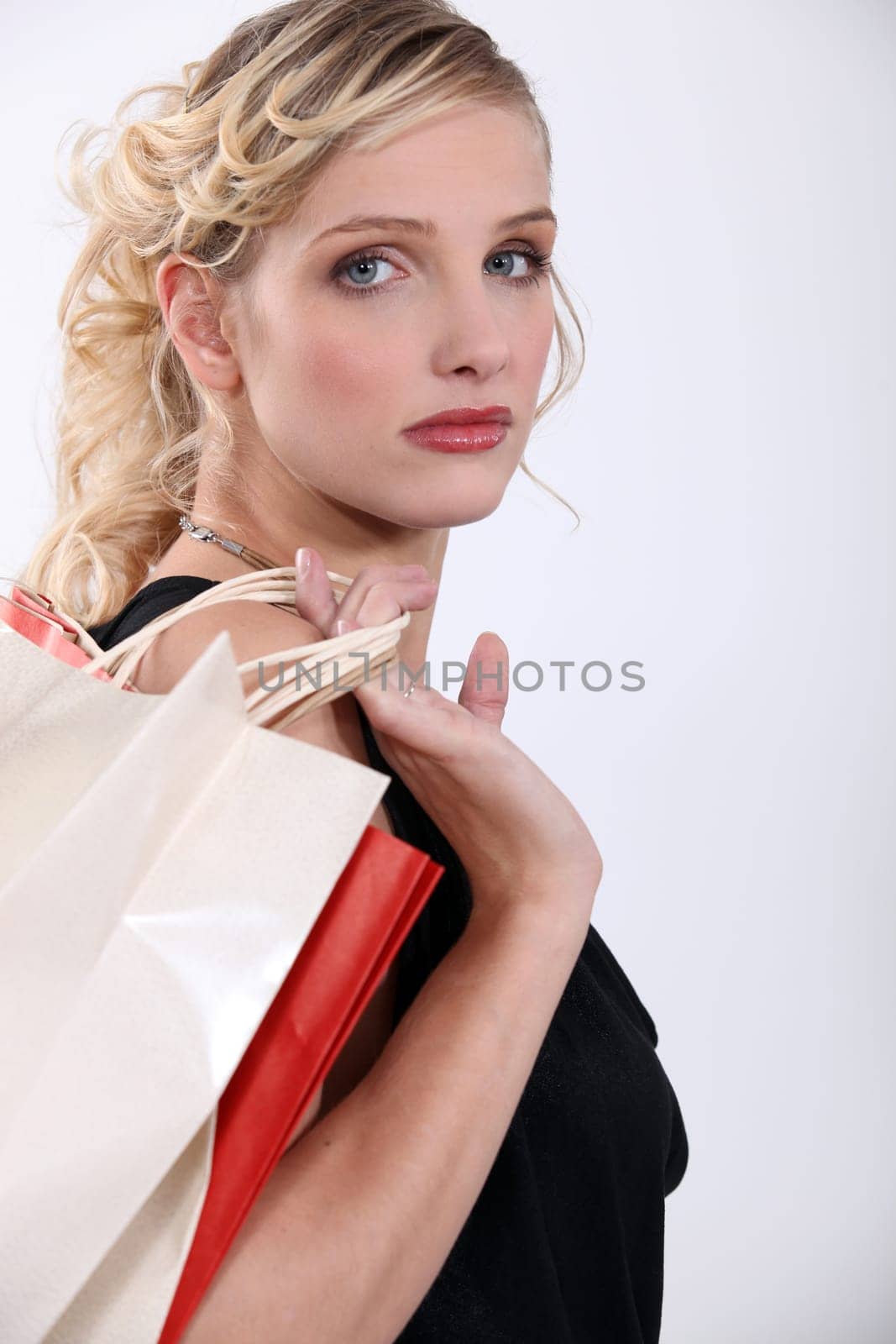 Glamorous woman with store bags