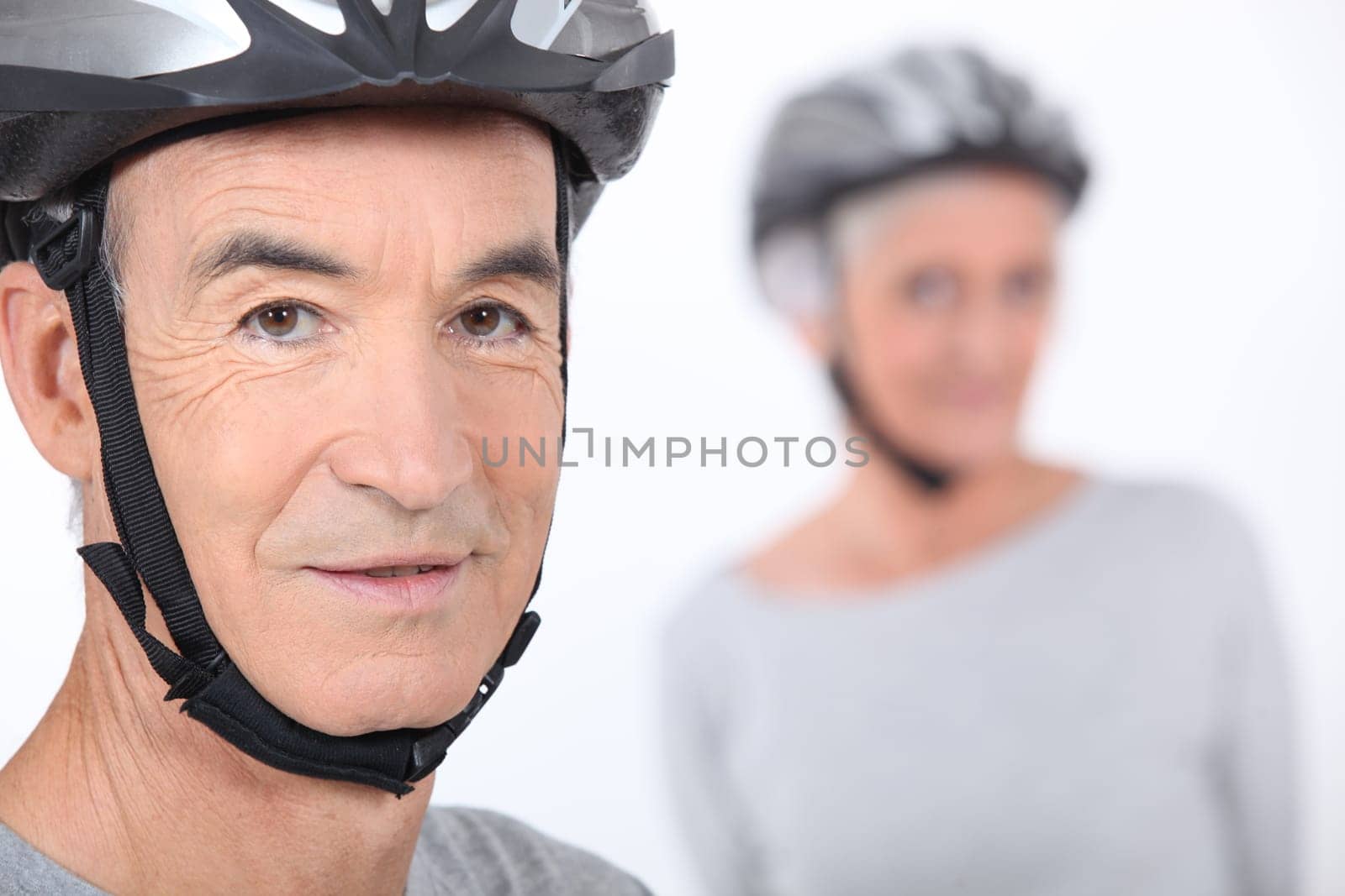 Senior man with a bicycle helmet