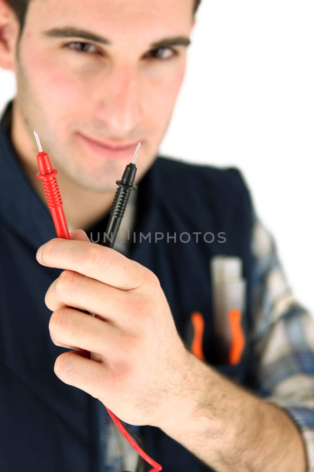 Electrician holding probes from voltmeter