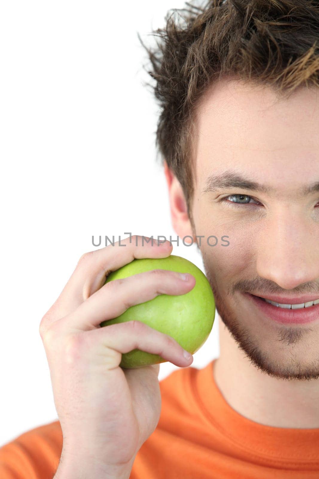 Young man holding a green apple
