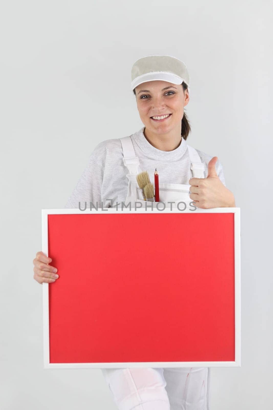Female decorator with a board left blank for your message