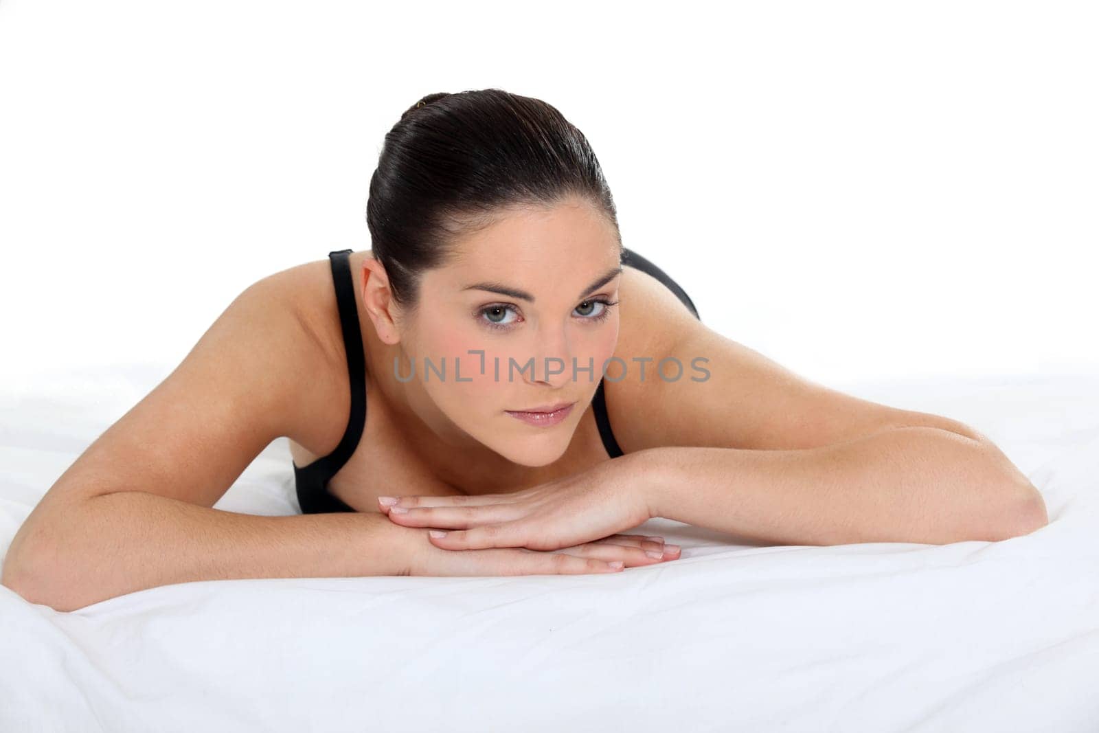 Woman lying on a bed in her underwear