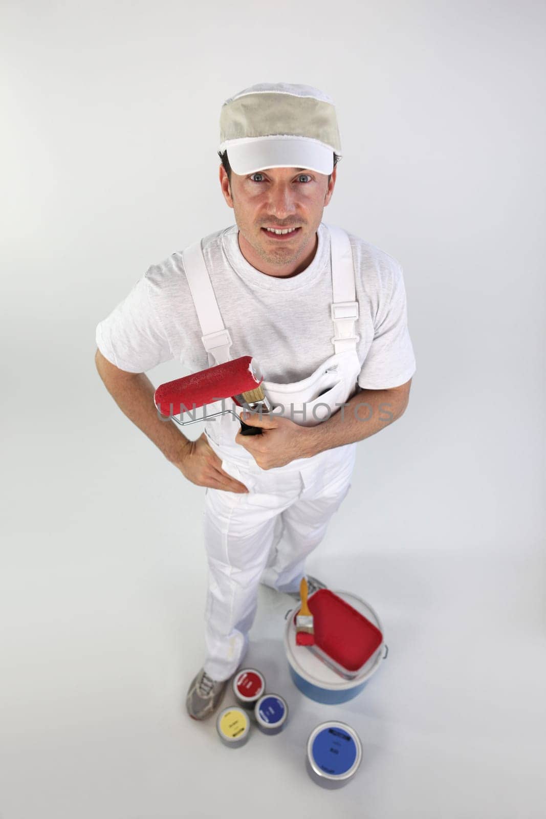 Decorator holding a paint roller