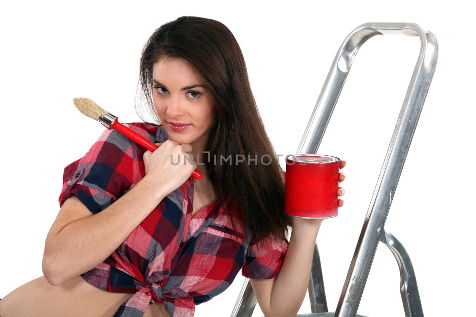 Young woman painting a room red