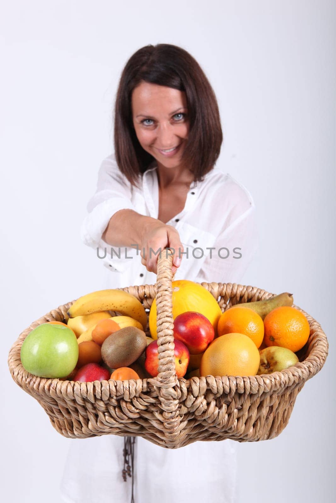 Woman holding basket of fruit