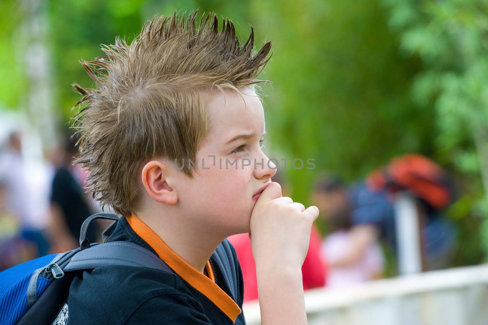 boy with stylish hair is reflecting
