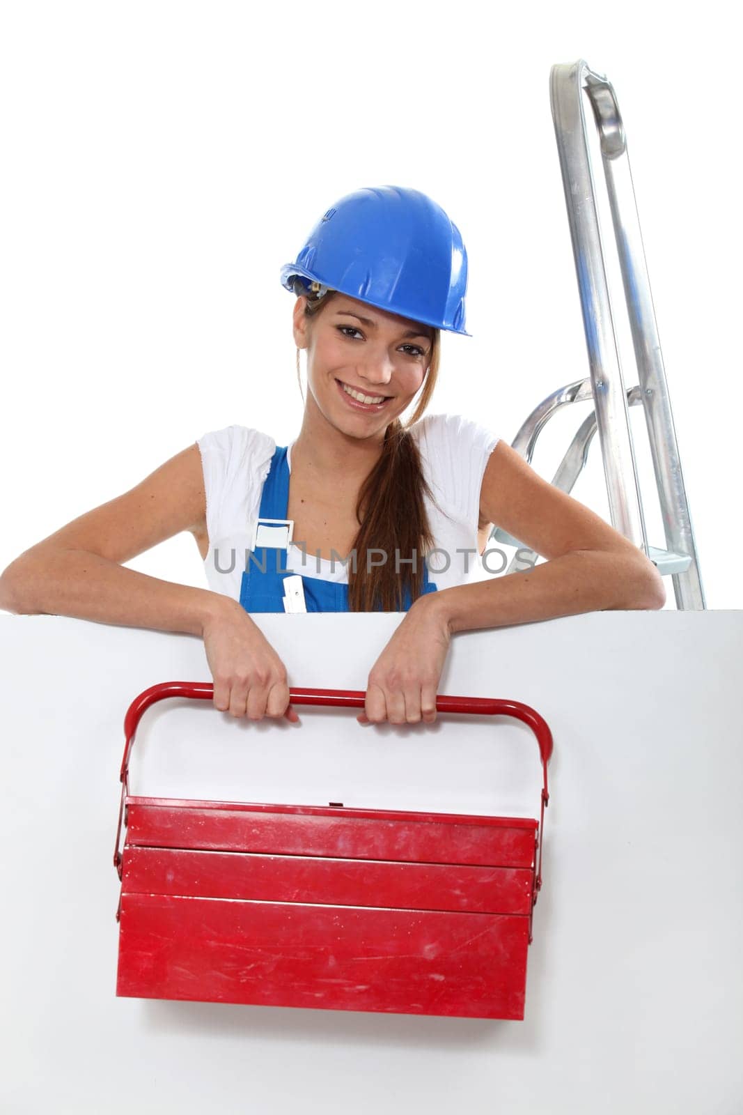Young woman with a large toolbox and a board left blank for your image