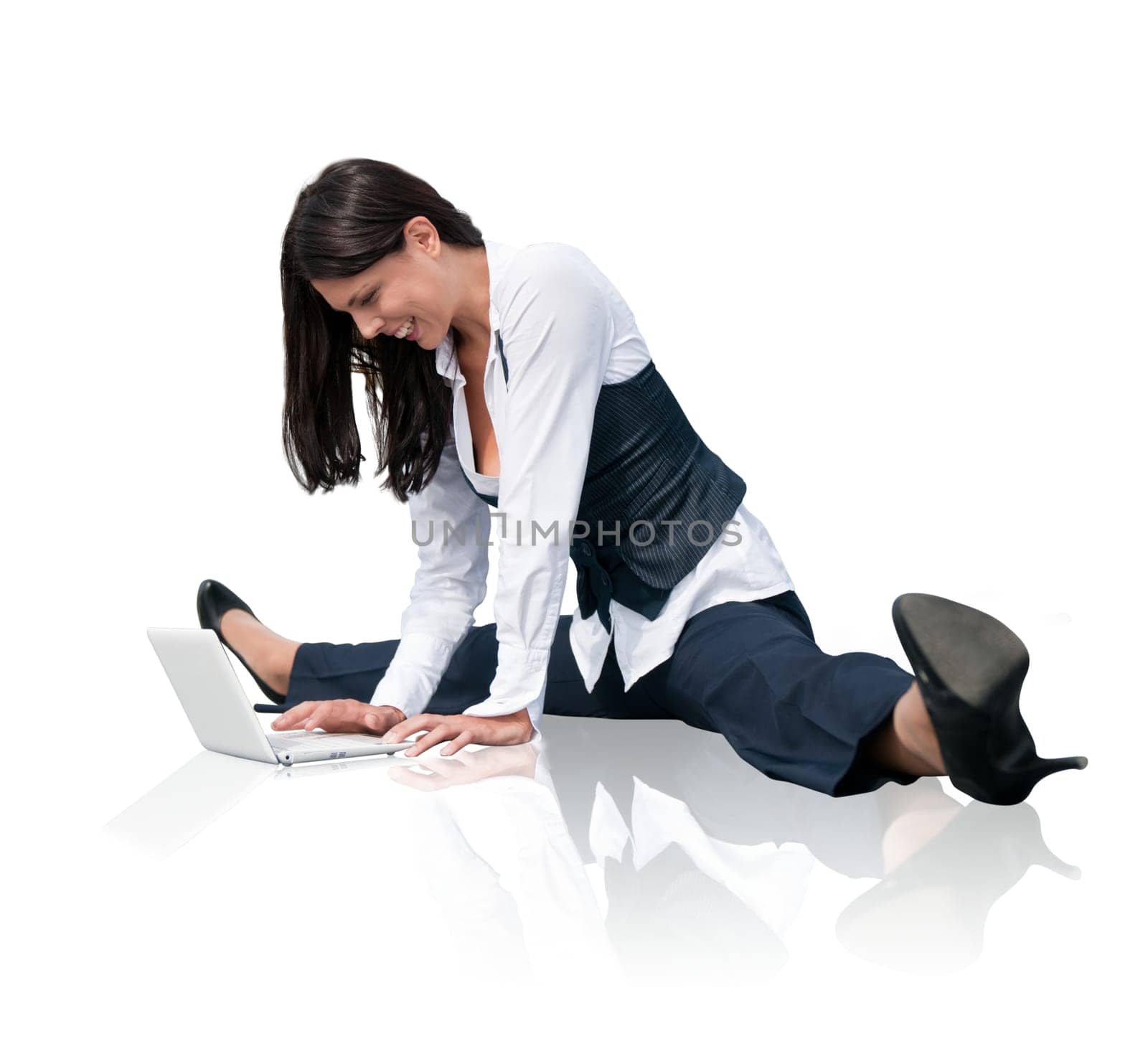 Young business woman in gymnastics pose working with computer - isolated on white