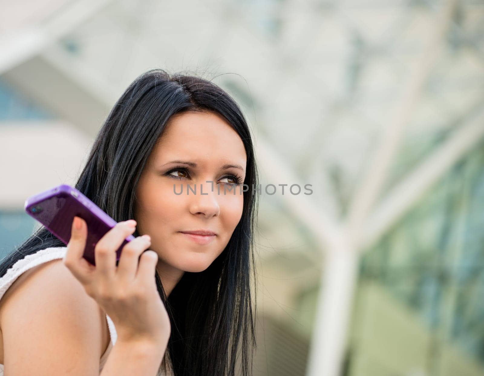 Young beautiful woman with mobile phone bored from call