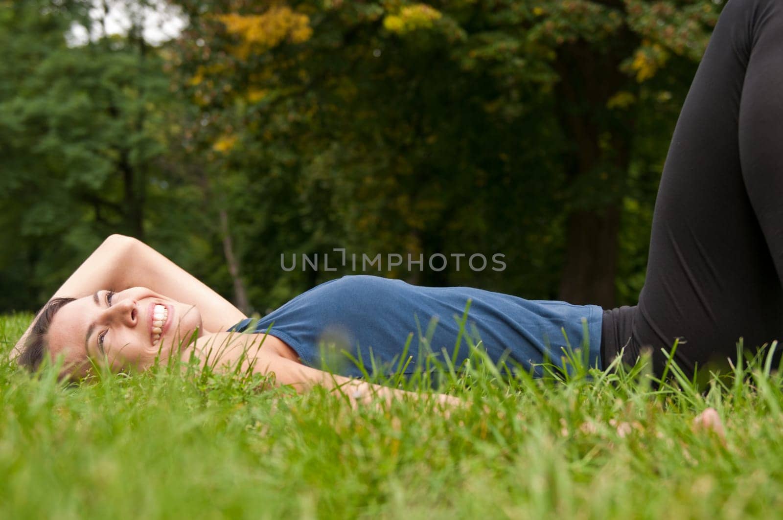 Enjoying life - woman lying in grass