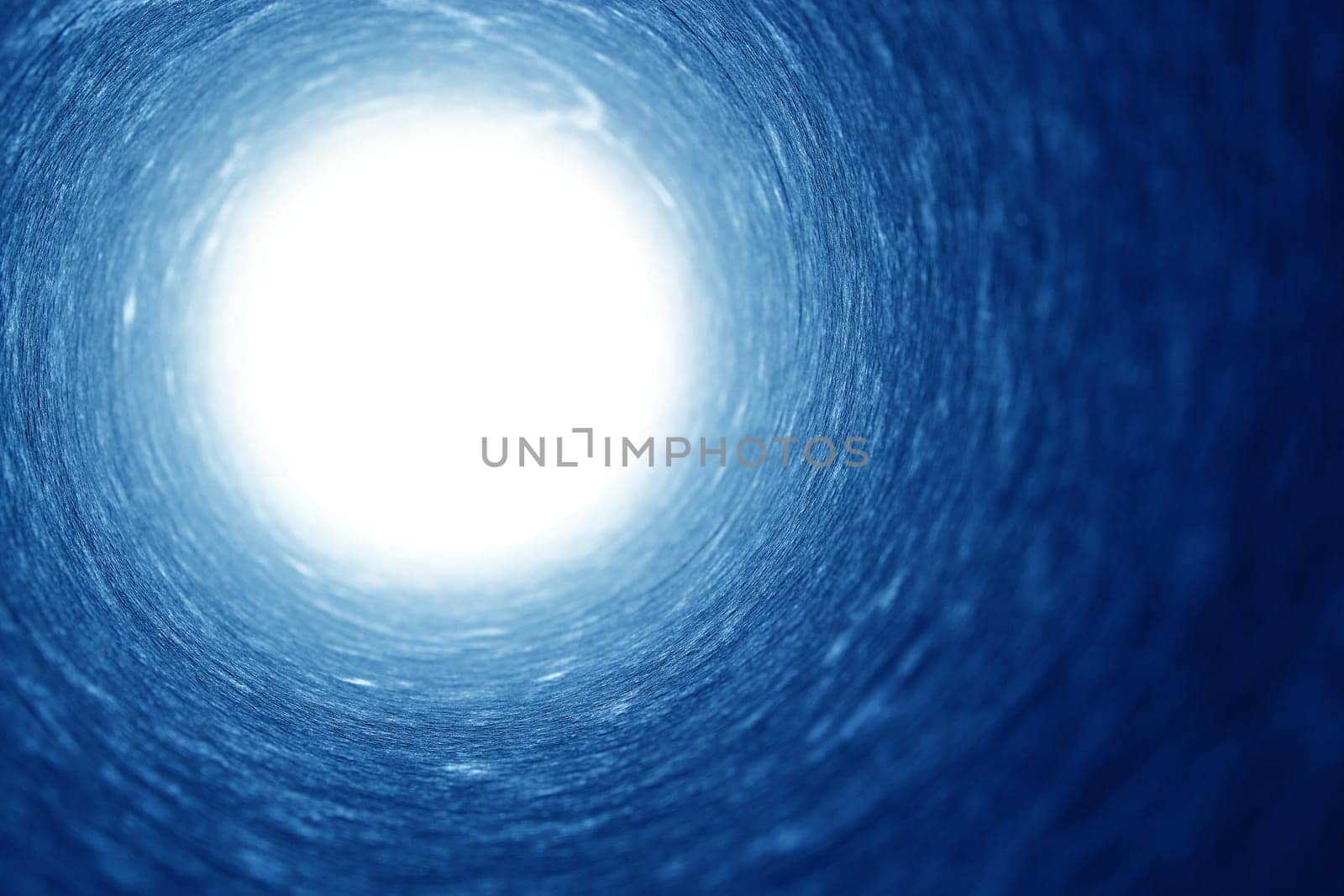 Shot of a cylindrical pipe with strong light at the end, metaphor for hope.