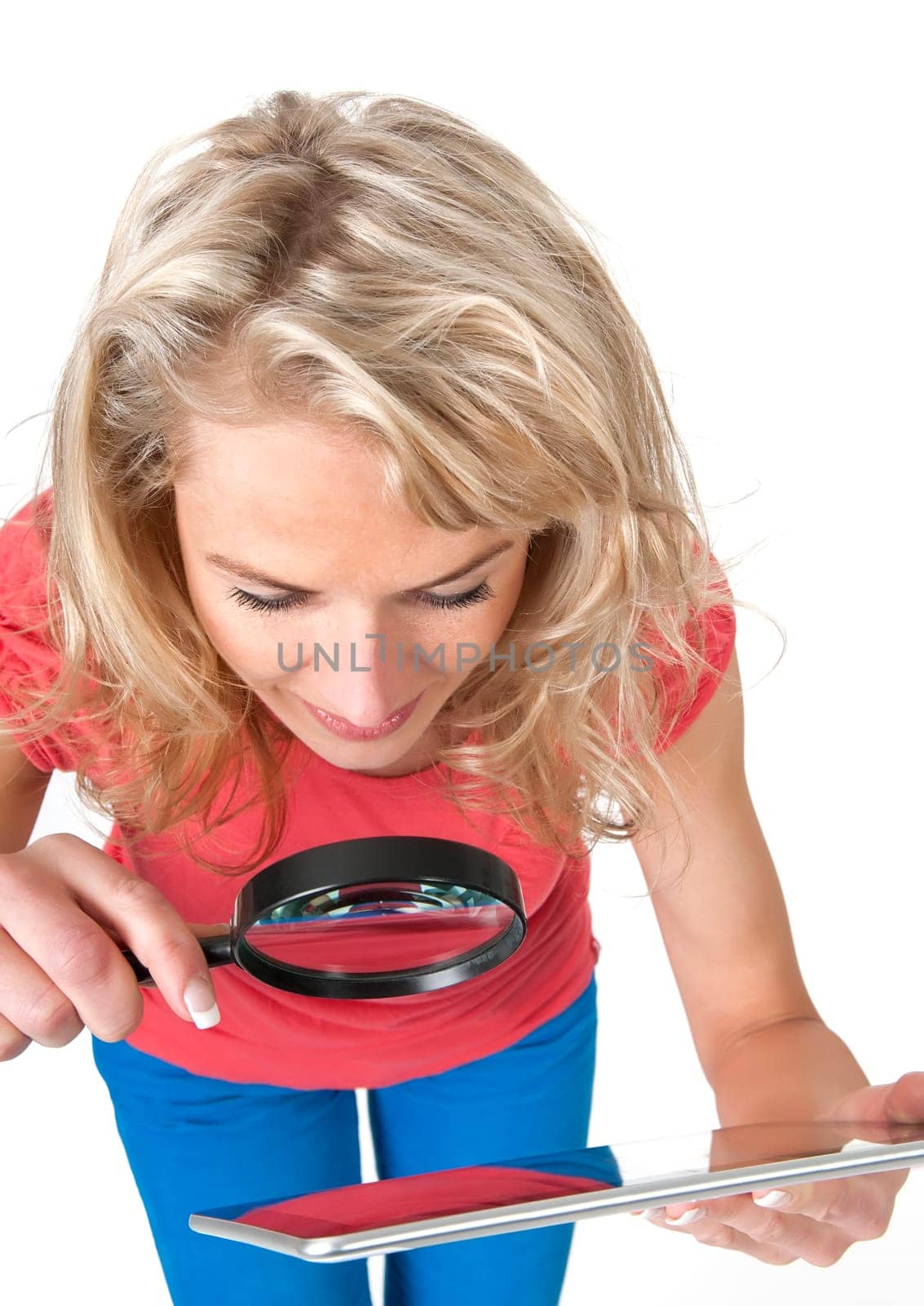 Woman with magnifying glass and digital tablet