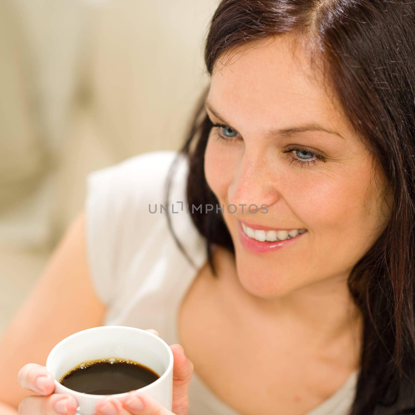 Close up of woman holding a cup of coffee