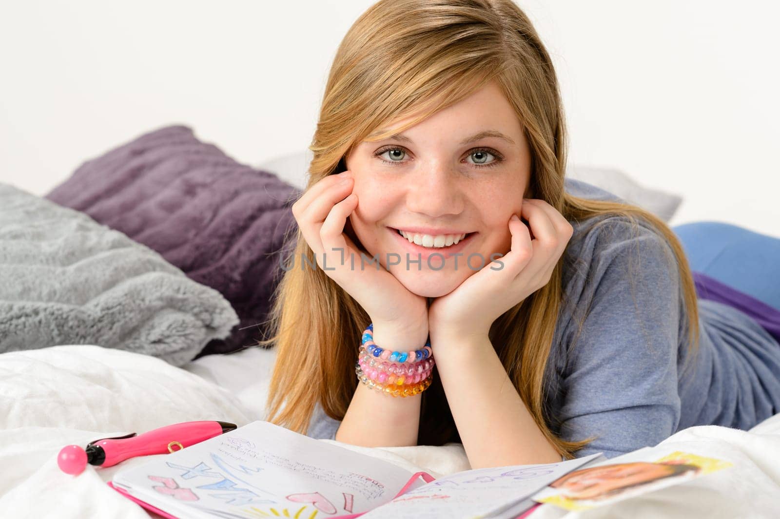 Dreamy girl daydreaming about love over her diary