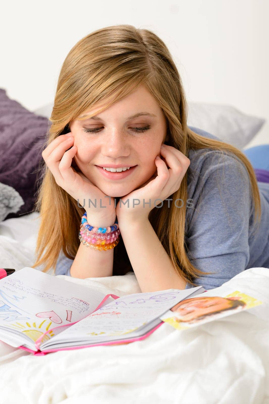 Friendly girl fantasizing over her diary about first love