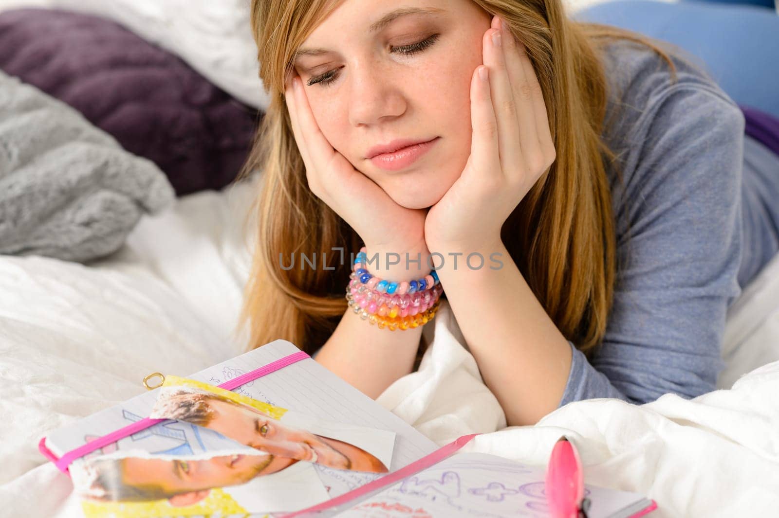 Depressed girl with broken heart and torn portrait of boy
