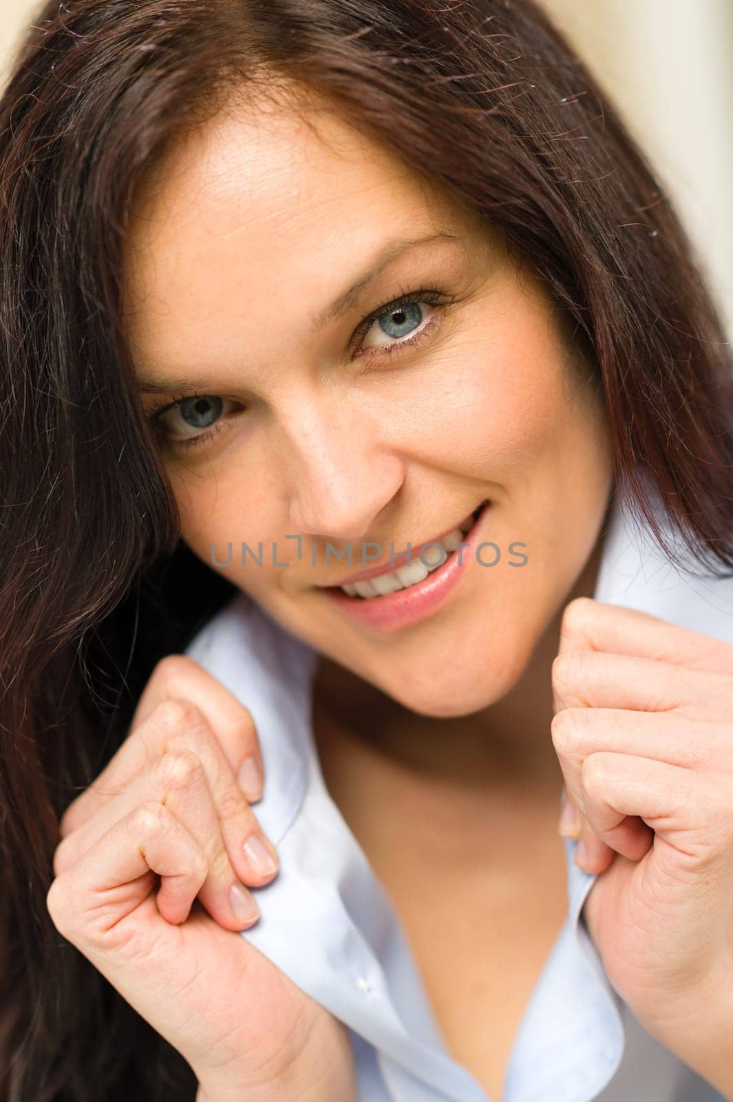 Close up of confident woman holding her shirt's collar