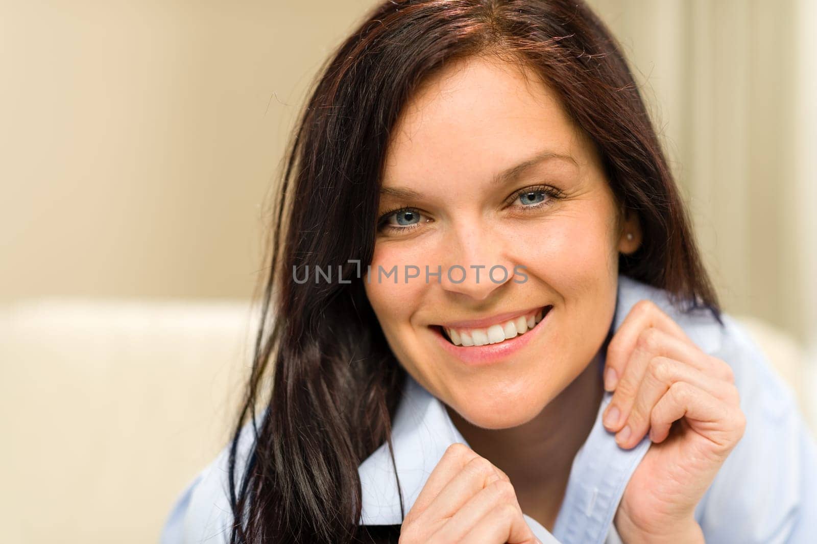 Portrait of pretty brunette woman holding her collar