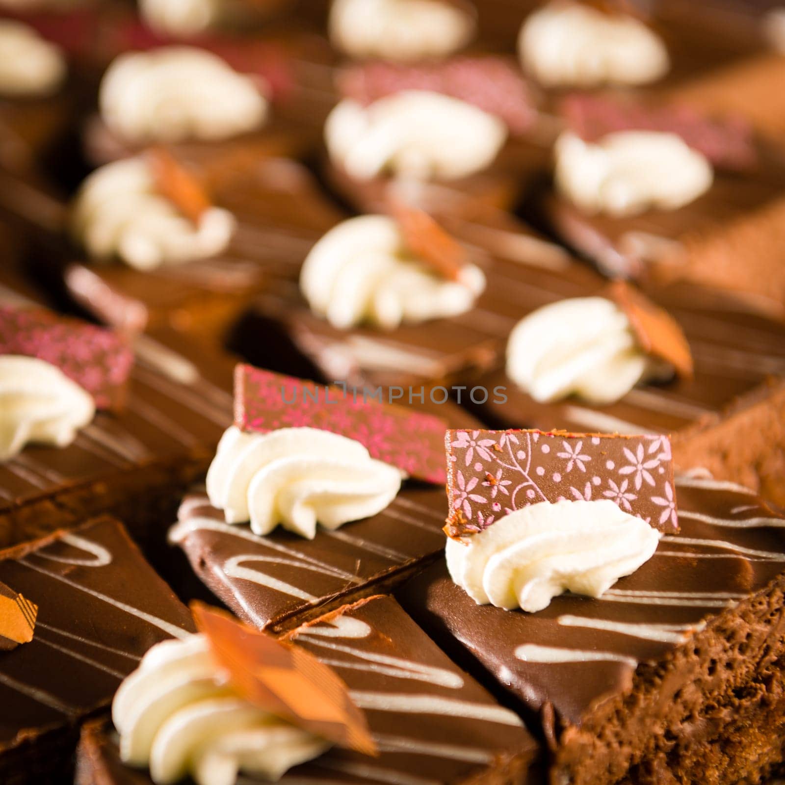 Tastefully decorated chocolate cake pieces with whipped cream