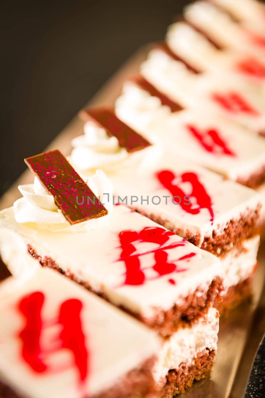 Chocolate cakes filled with vanilla cream decorated with icing