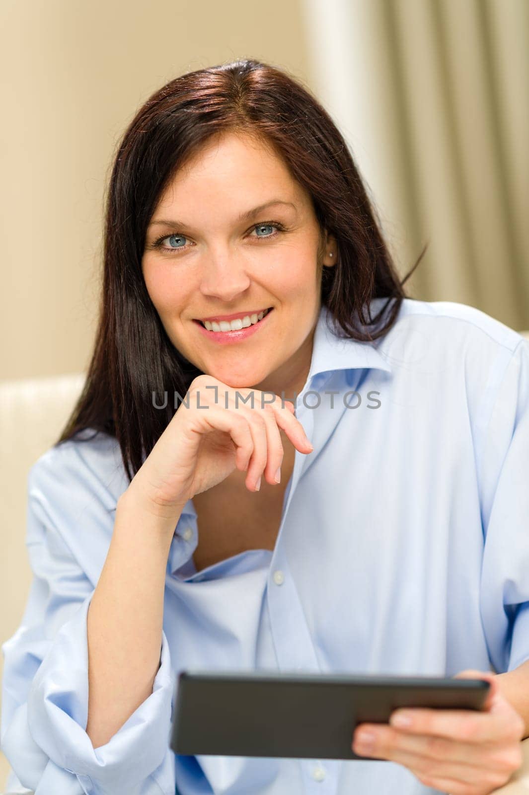 Confident smiling woman with digital tablet