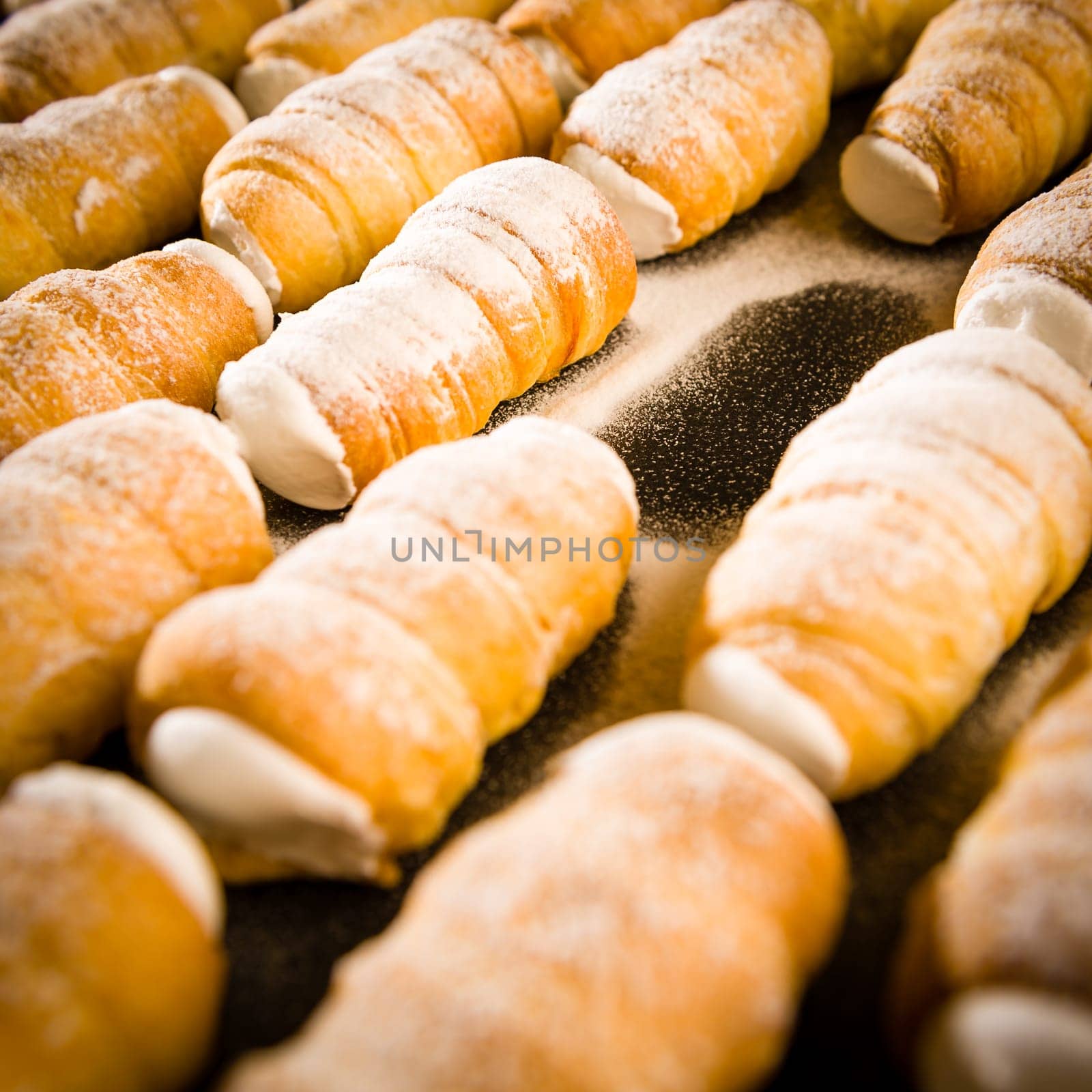 Cream horns filled with whipped cream decorated with powder sugar