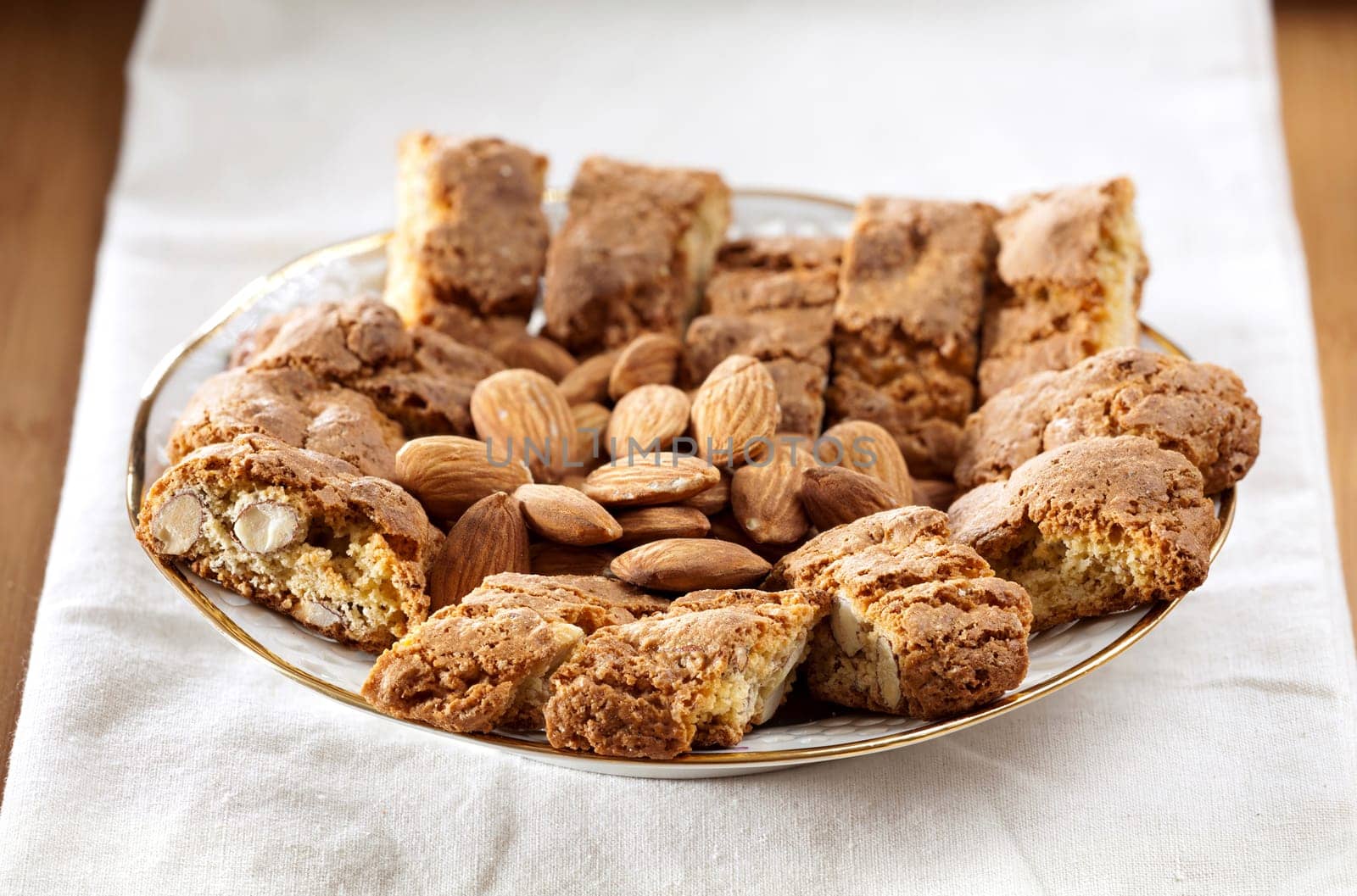Cantuccini pastries and almond kernels as a close-up on a tablecloth