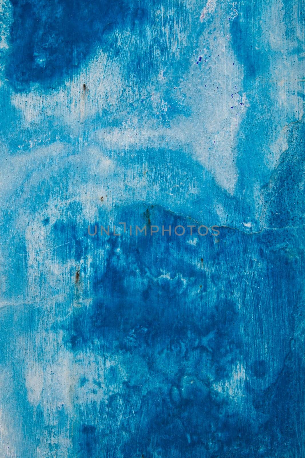 Faded blue painted wall background texture with white streaks