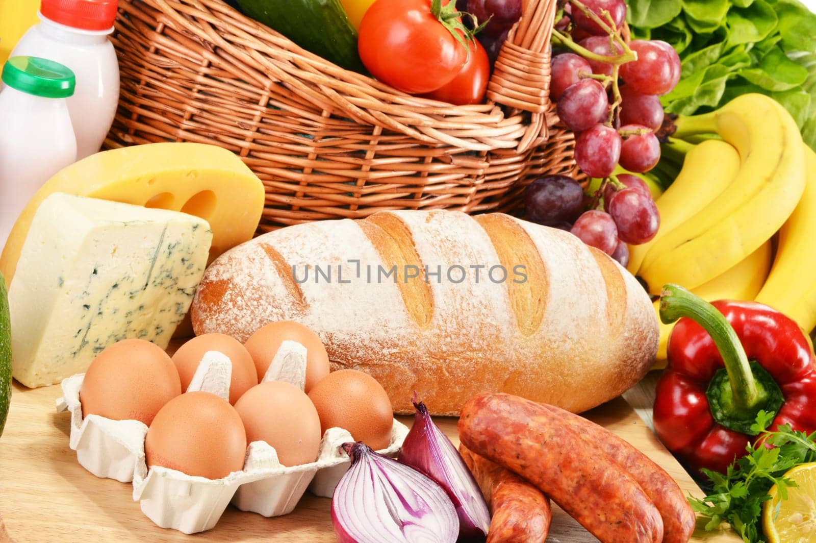 Assorted grocery products including vegetables fruits wine bread dairy and meat