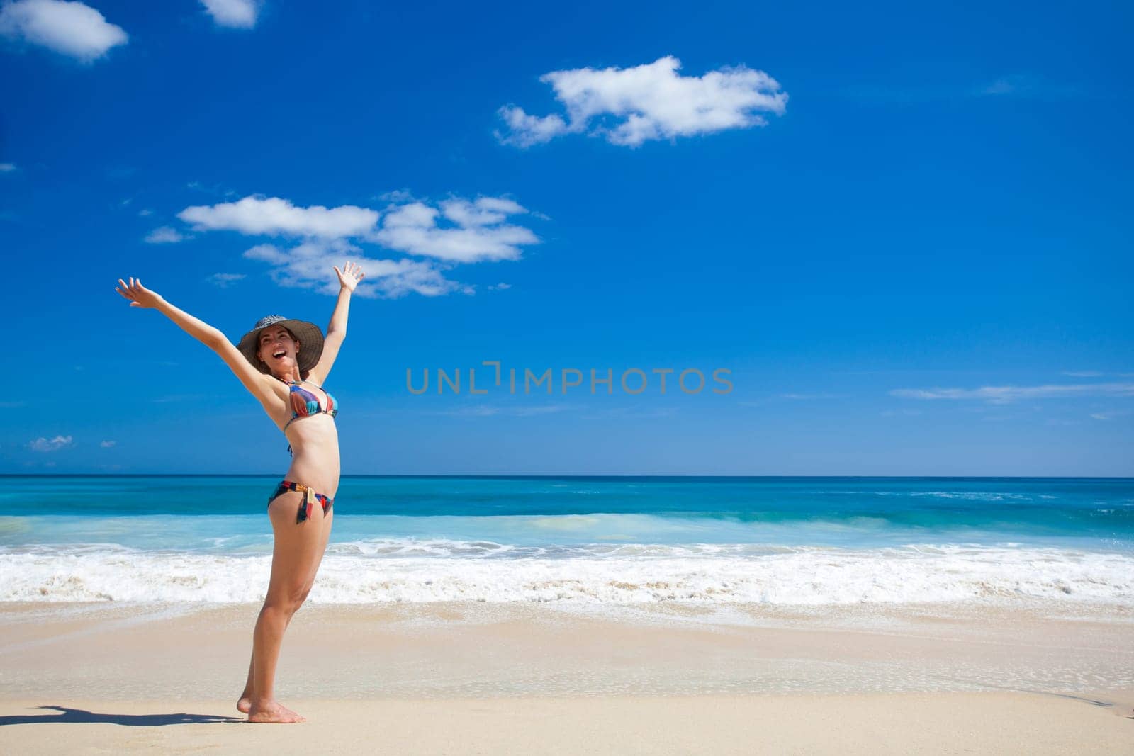 Beautiful young woman enjoying the summer in a tropical beach