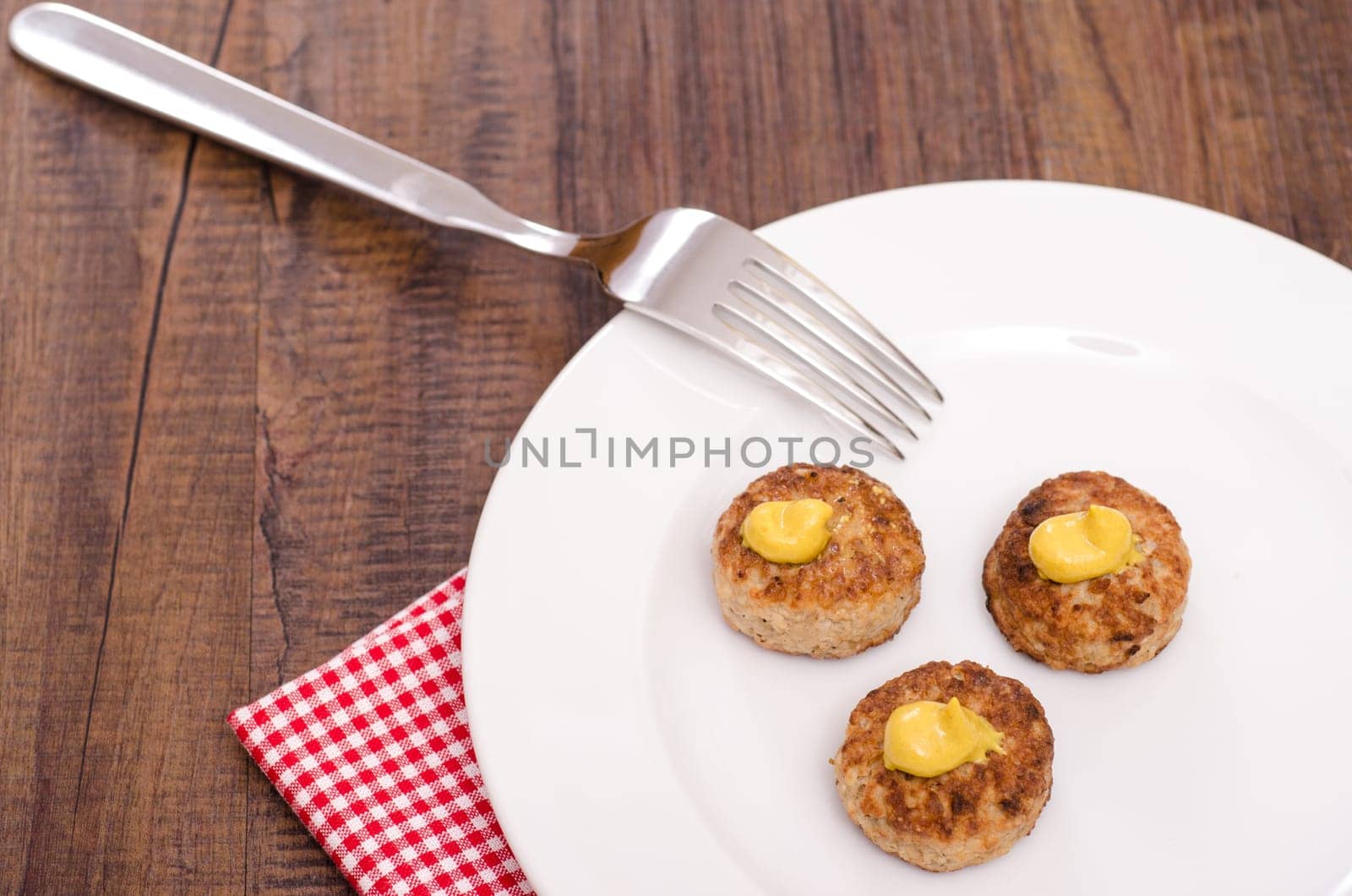 Meatballs on a white plate with fork