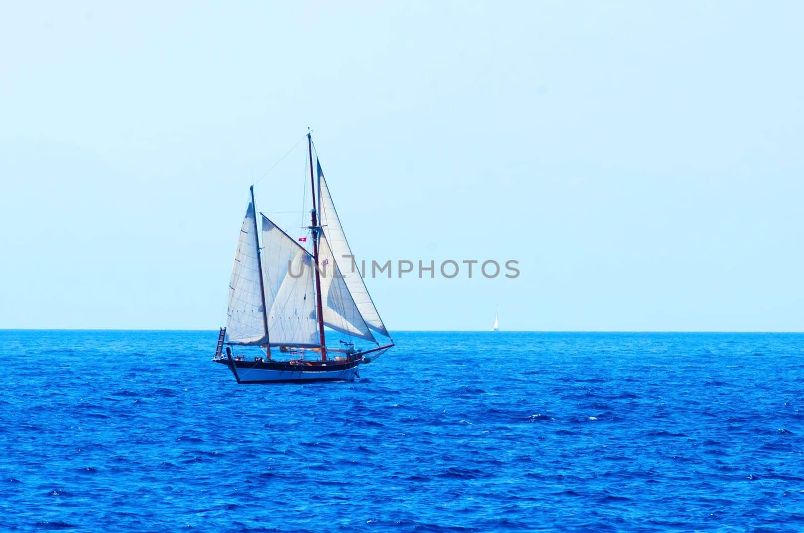 A sailing boat crossing the sea/ocean