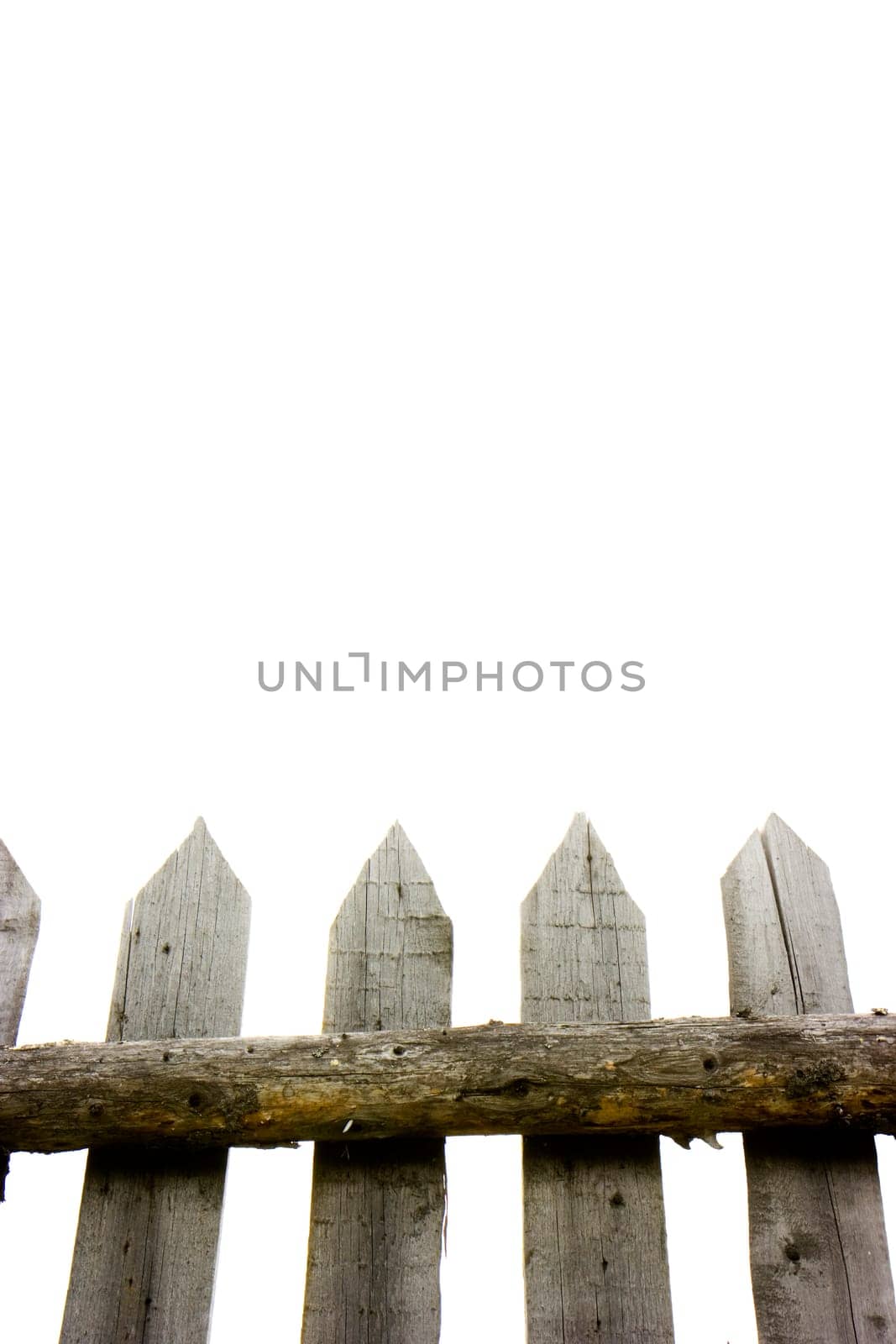 Photo of an old fence against the light sky