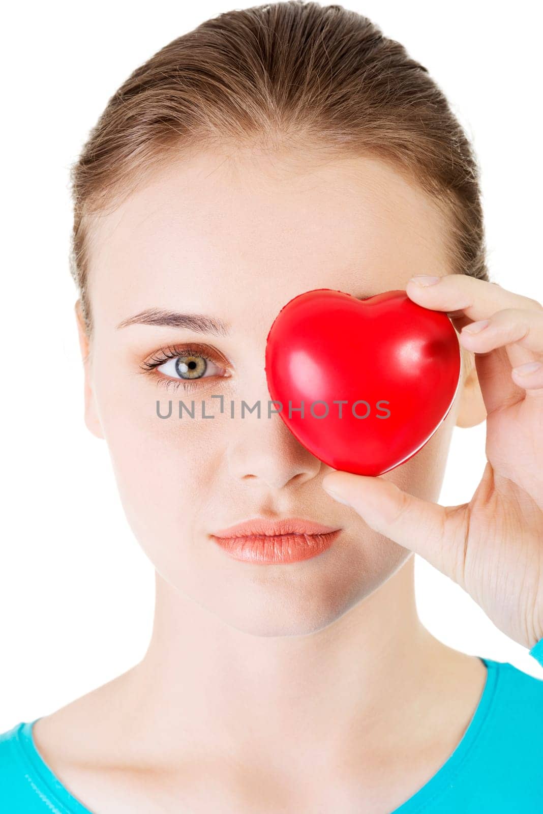 pretty girl showing red heart in her hand over white.