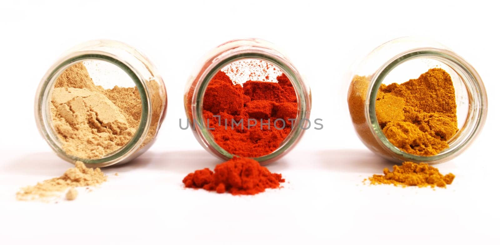 Variety of spices in a glass pot, focus in the back.