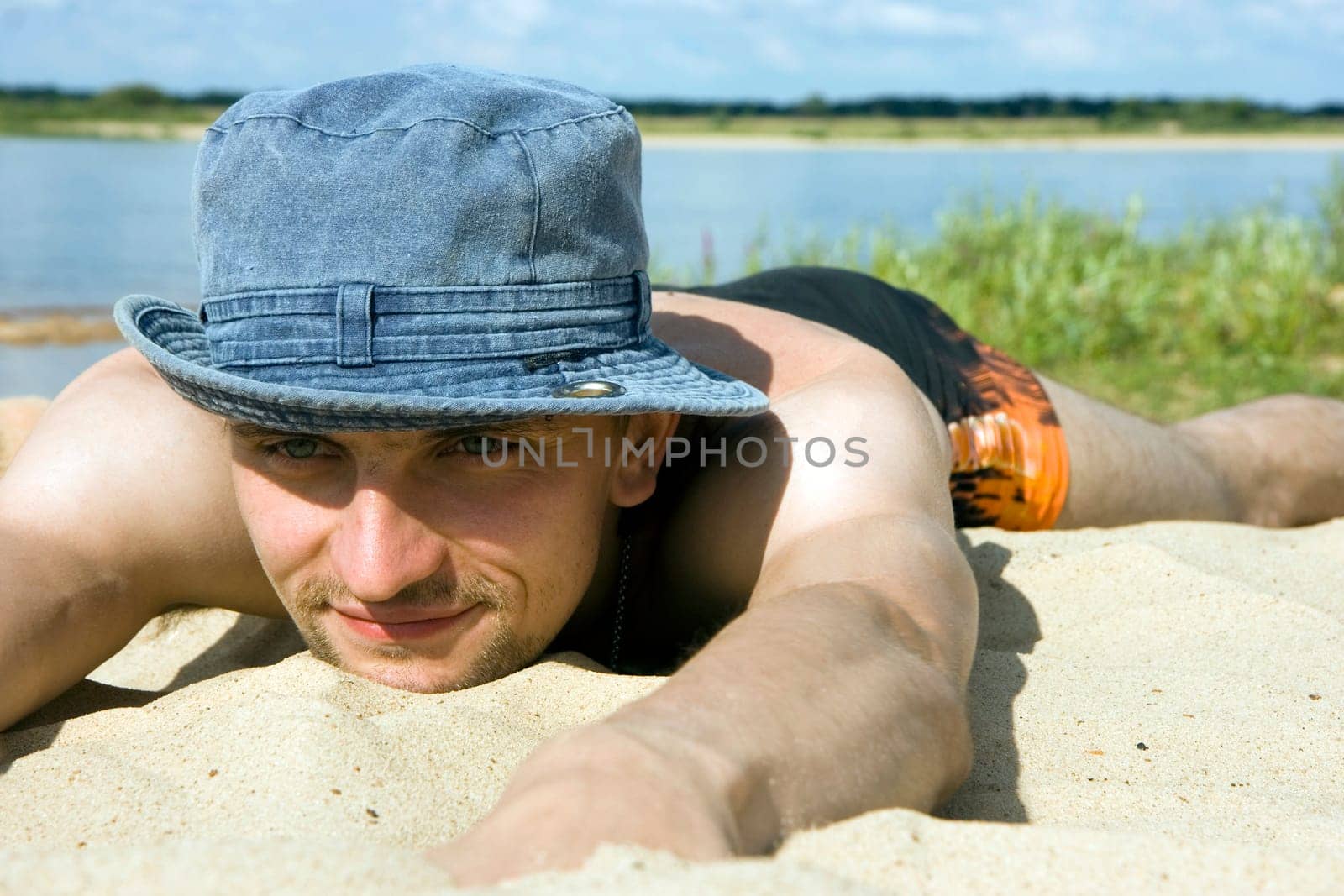 Photo of the man lying on a beach
