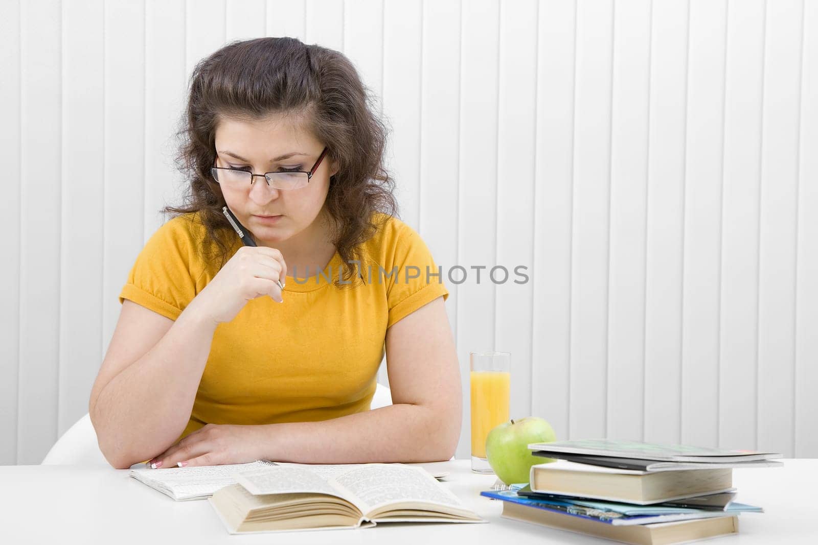 girl student sitting at a table in the classroom