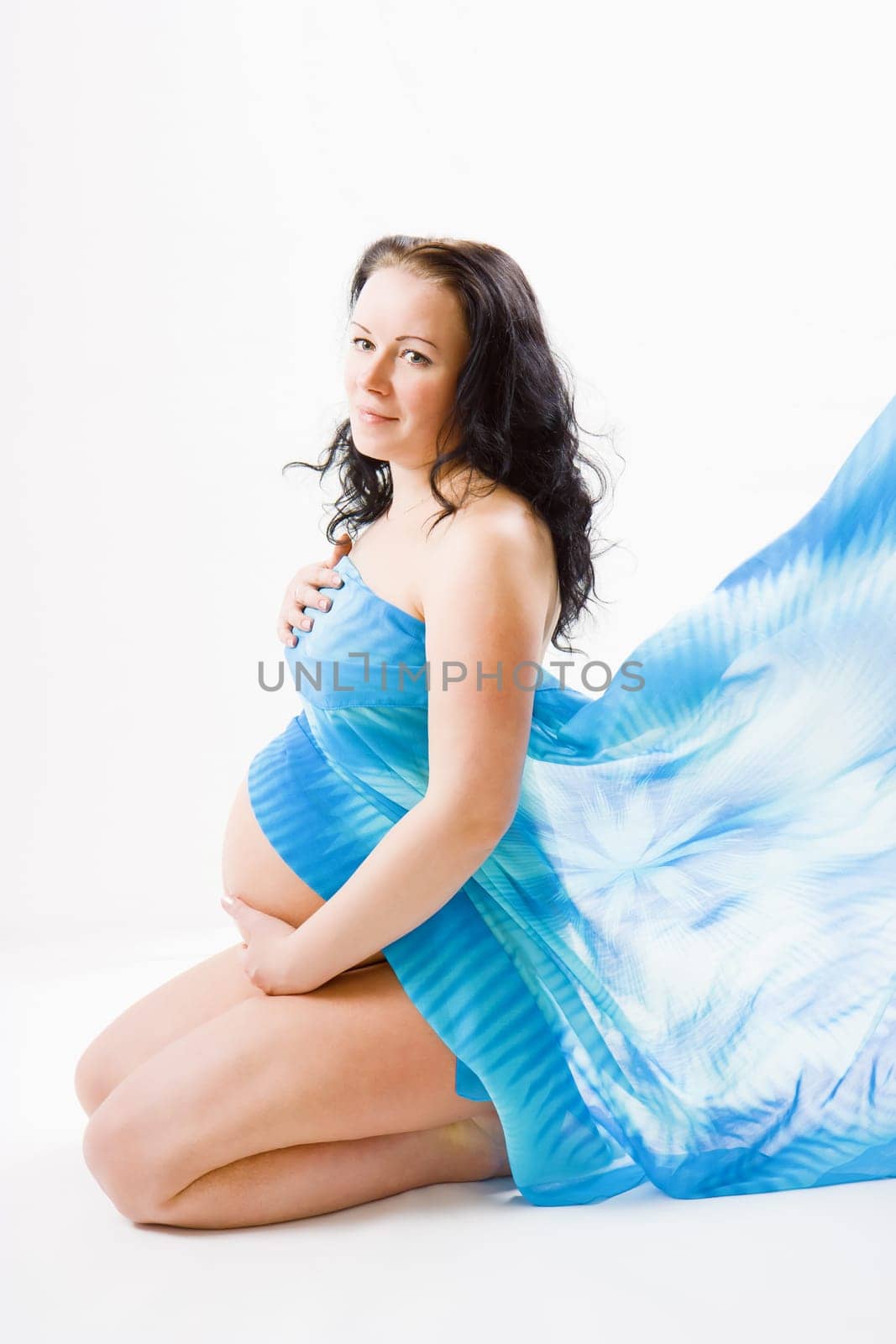 pregnant girl on a white background in studio