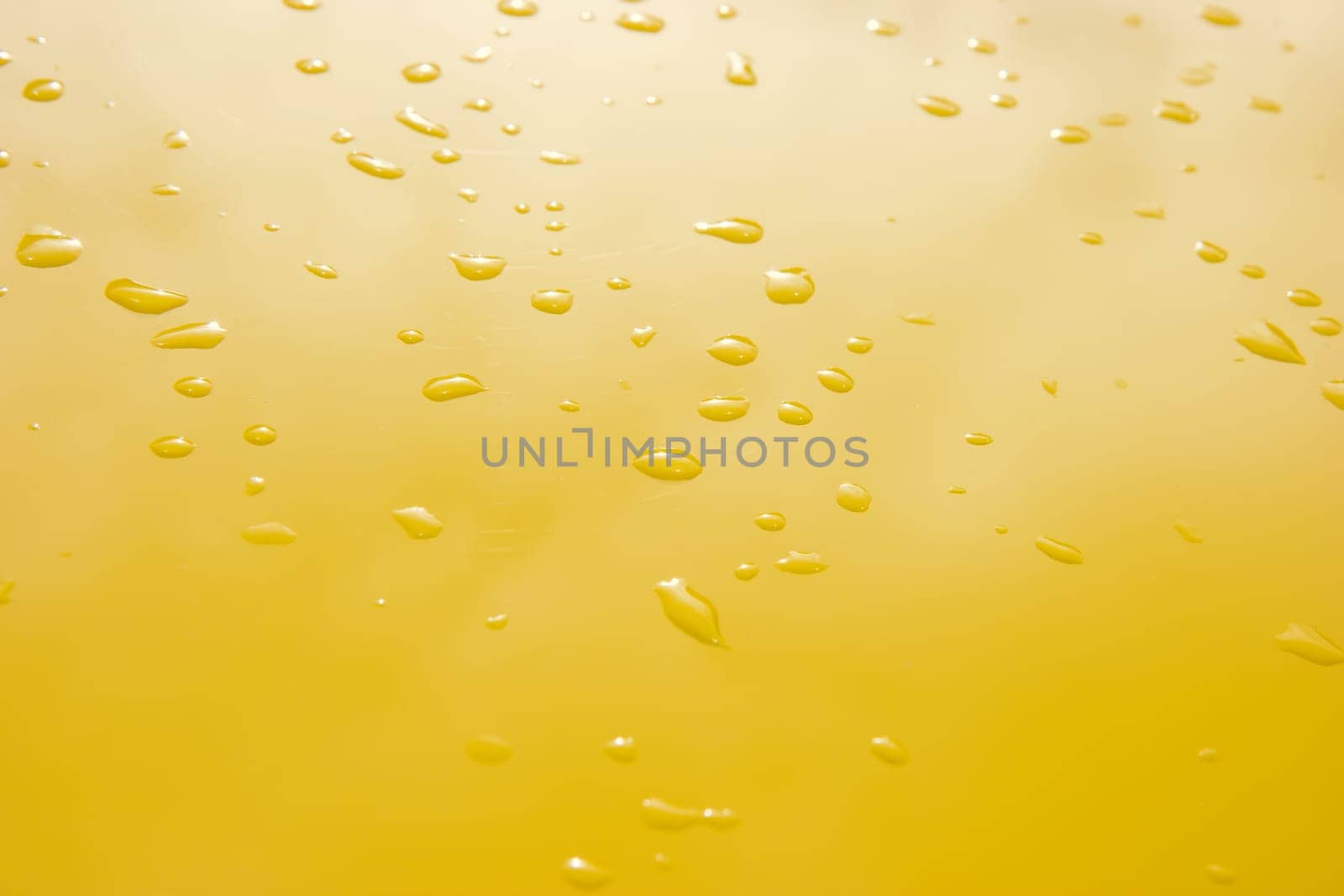 raindrops on the surface painted in yellow metal