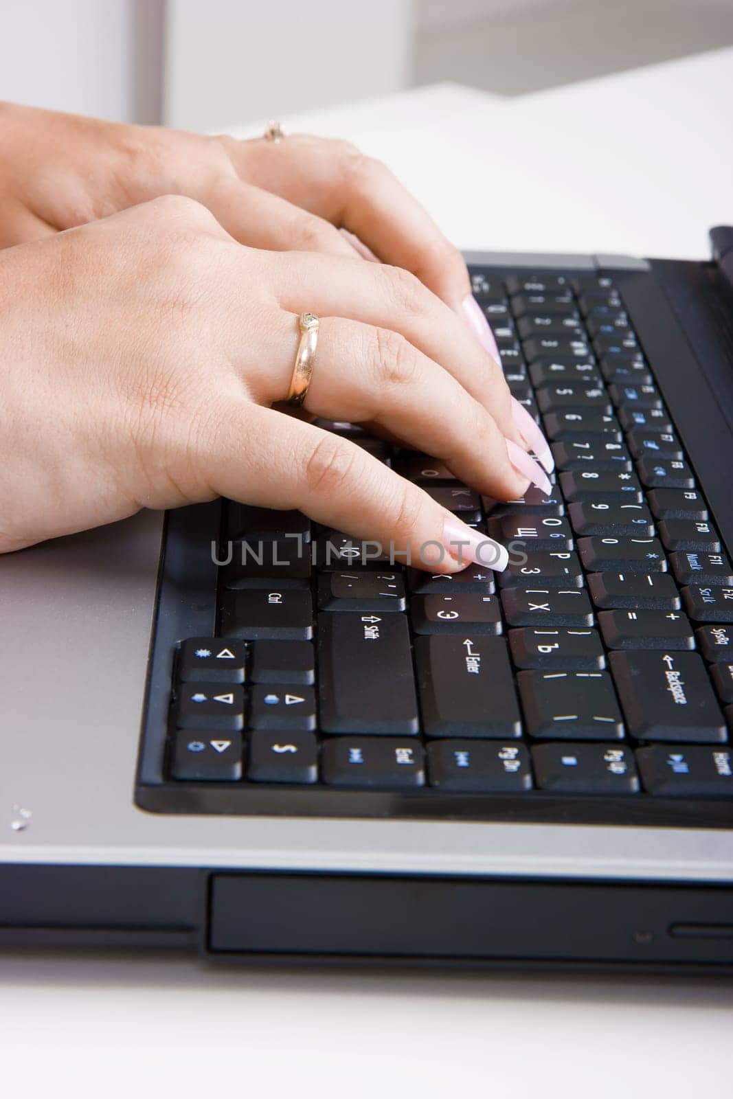woman's hands with a manicure on a laptop keyboard