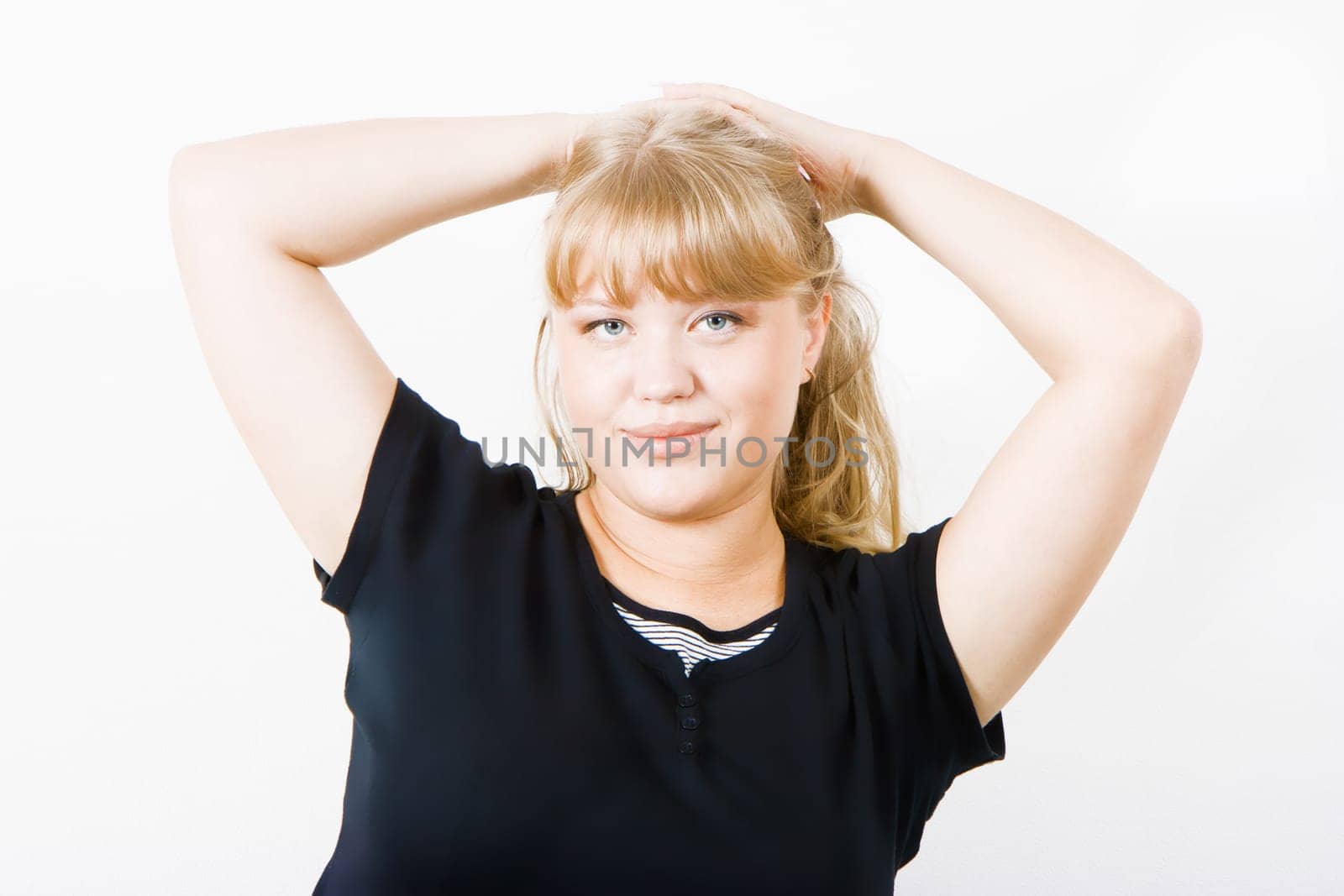 cute chubby blonde posing on a white background