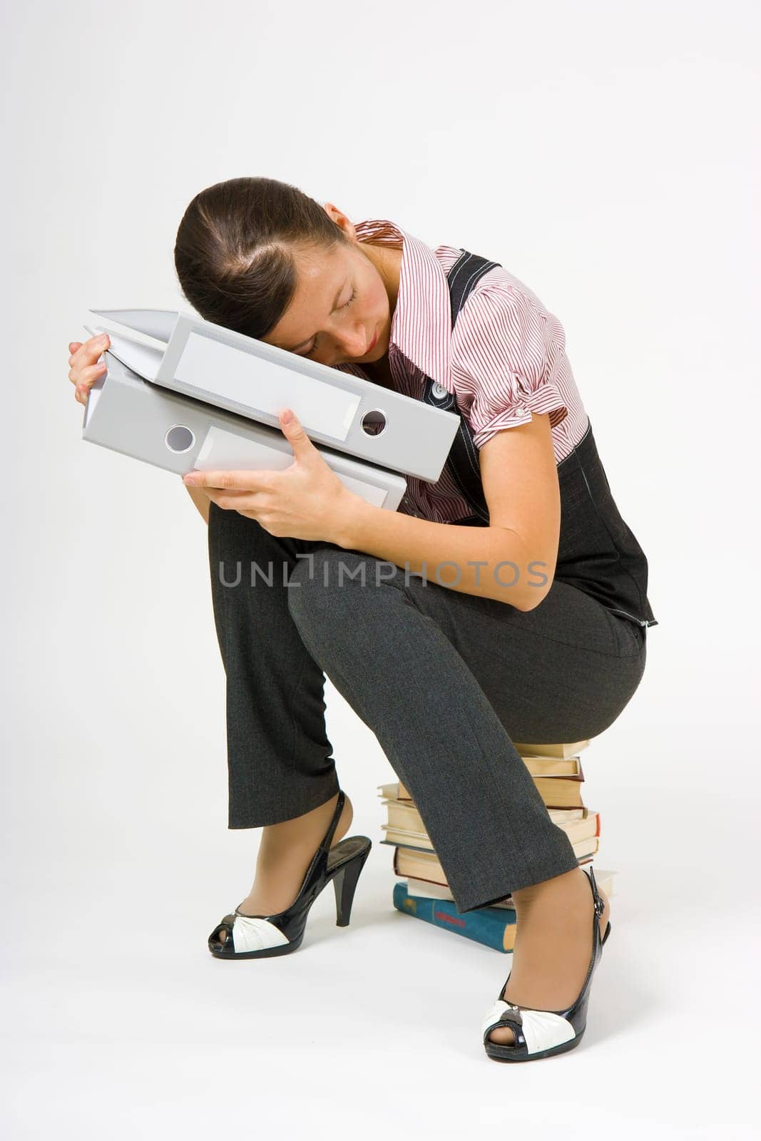 tired businesswoman sleeping on the books on a white background