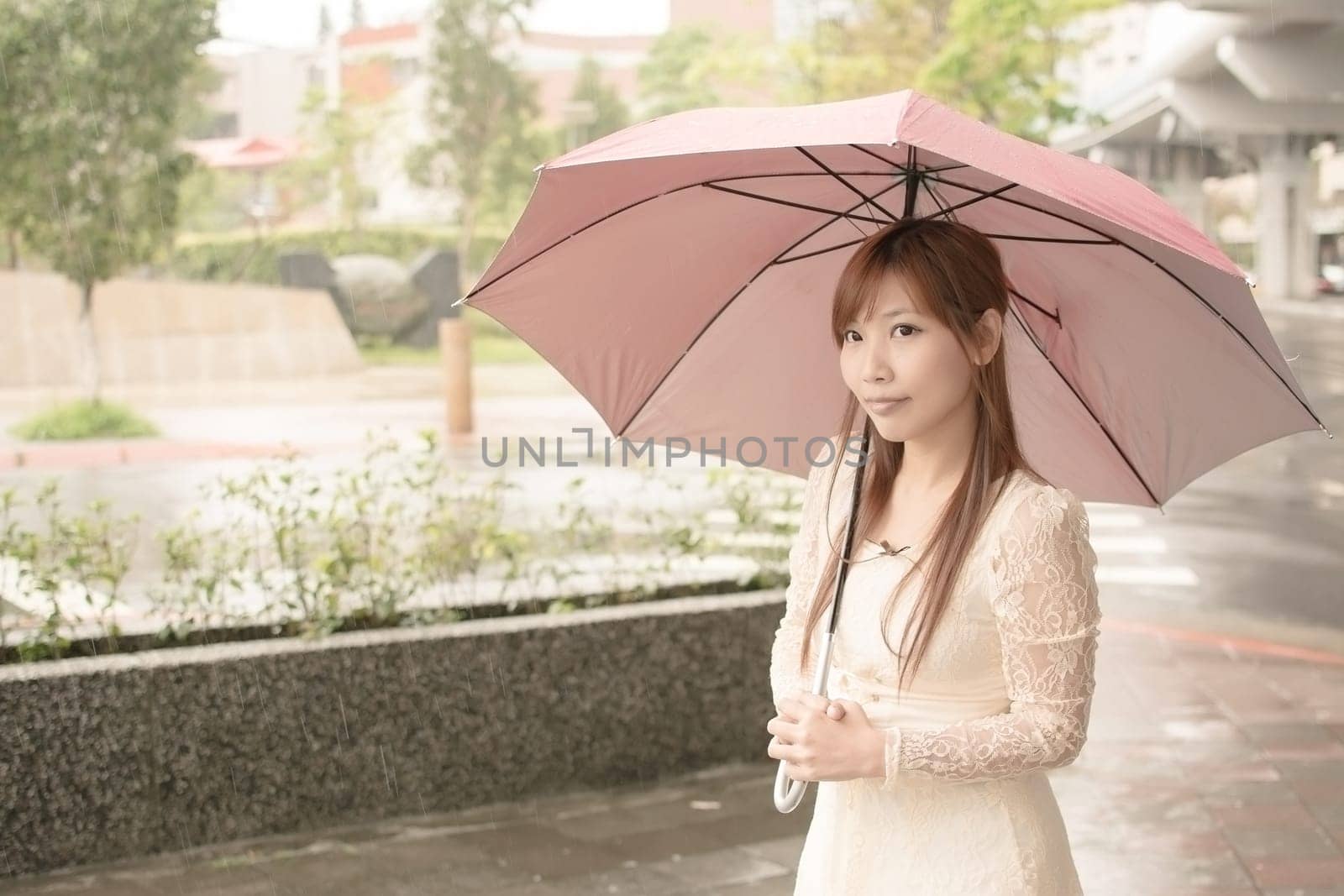 Asian beauty in raining day hold an umbrella in outside, Taipei, Taiwan.
