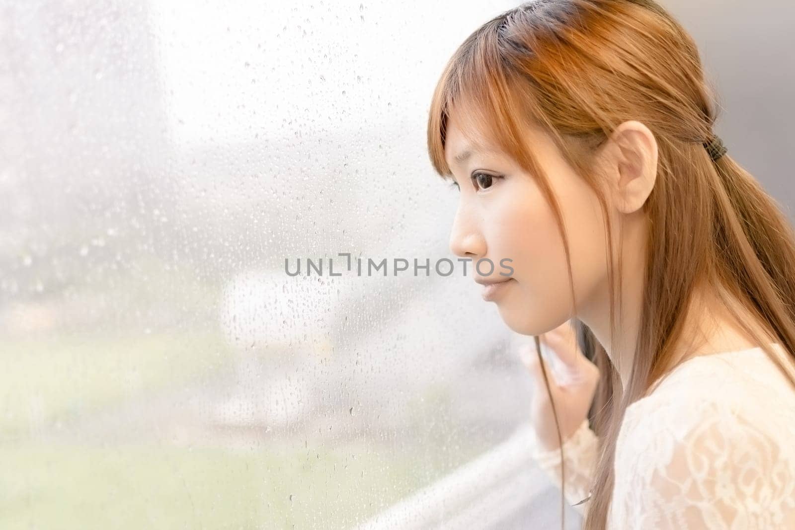 Asian beauty in MRT carriages look through the window into far away, Taipei, Taiwan.