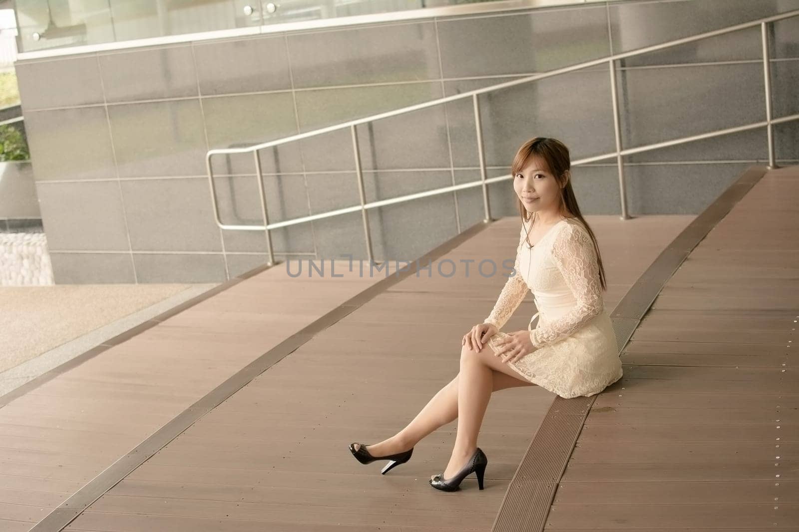 Asian beauty sit on ground and look far away in Taipei, Taiwan, Asia.