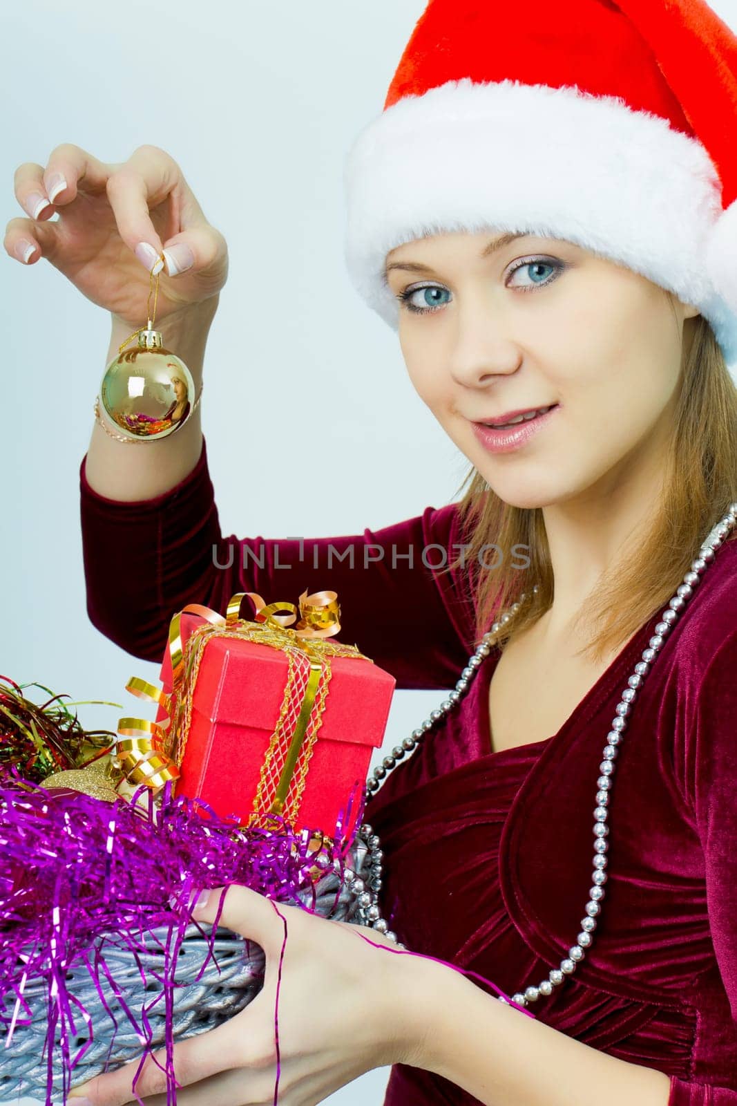smiling girl in Santa hat with Christmas decorations