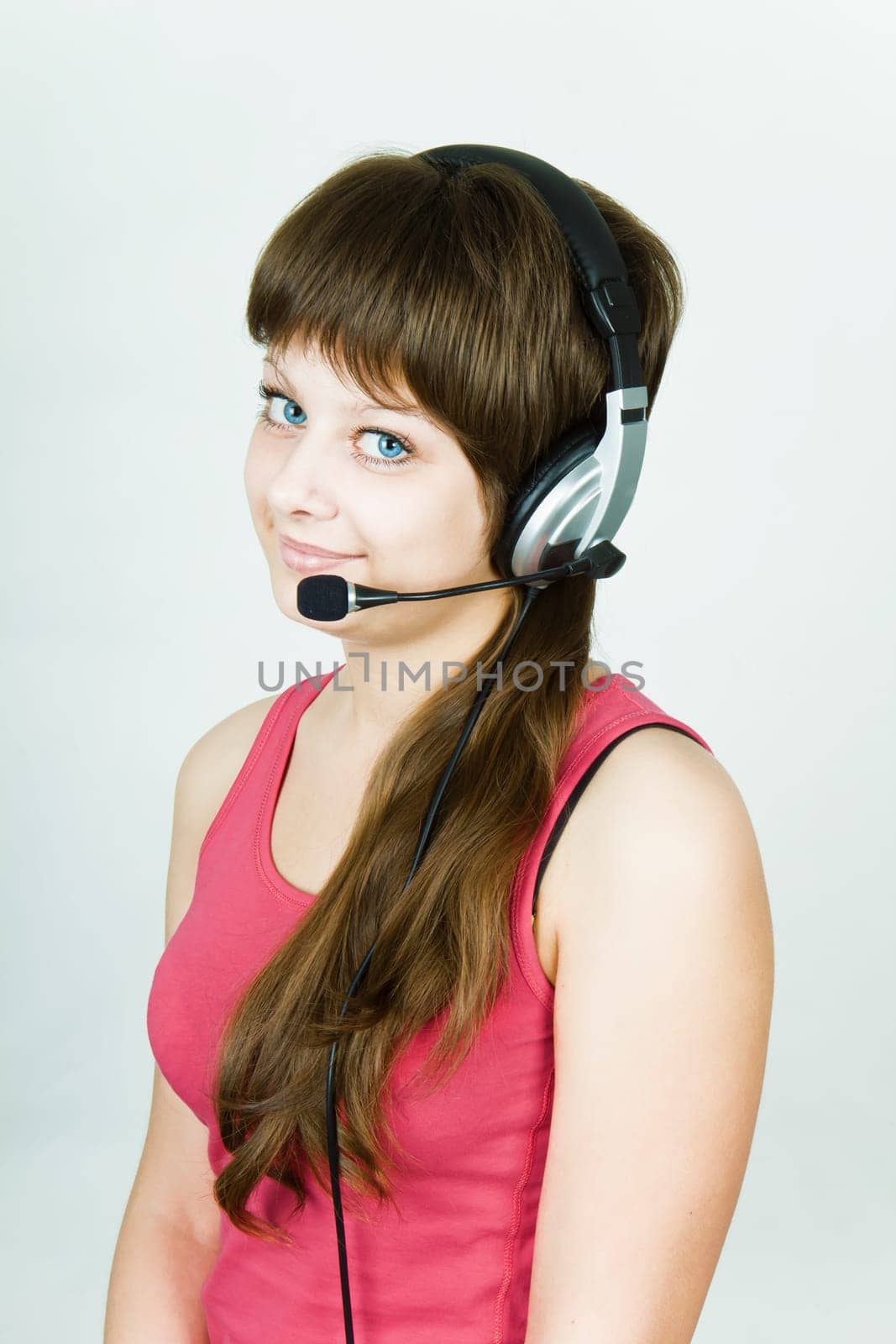 beautiful young smiling girl in headphones with microphone
