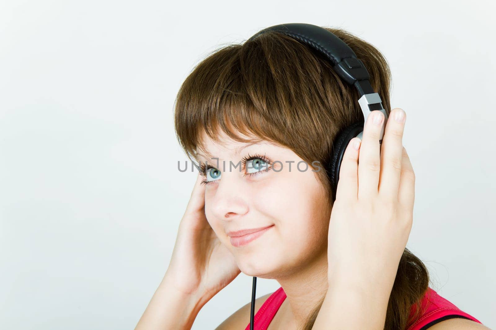 beautiful smiling girl teenager in the headphones